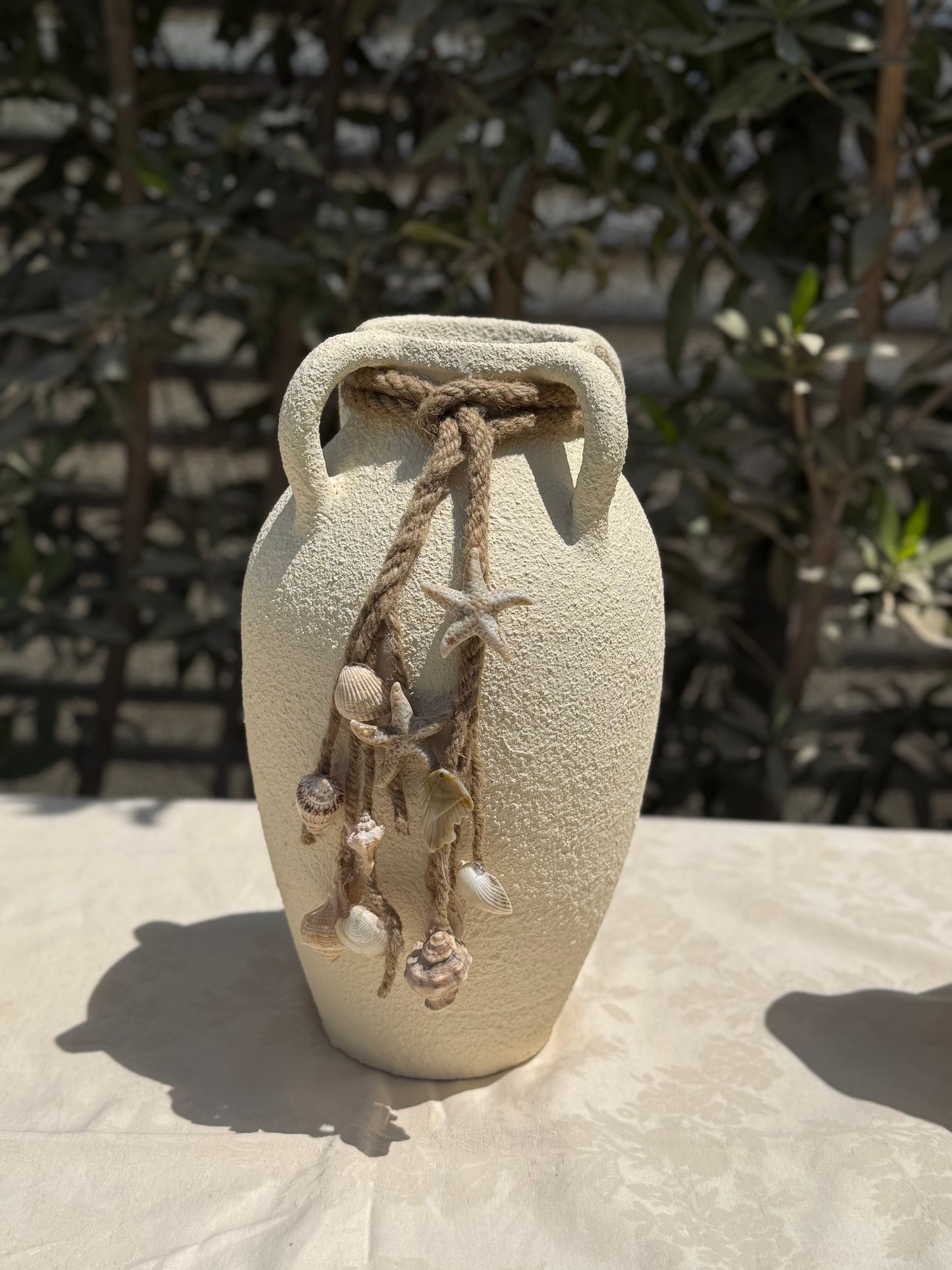 Pottery vase with shells
